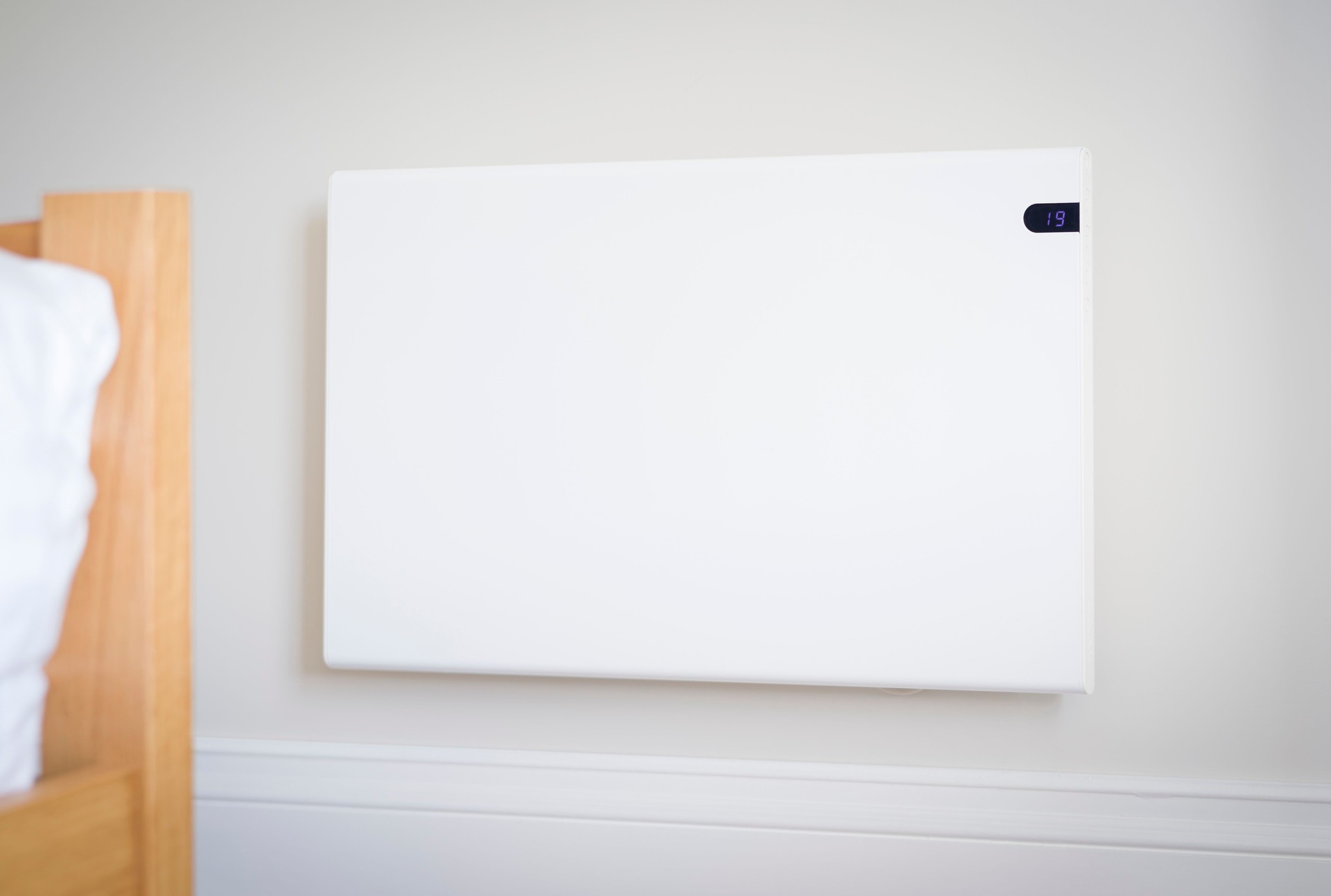 Electric heating panel radiator on a bedroom wall, UK home